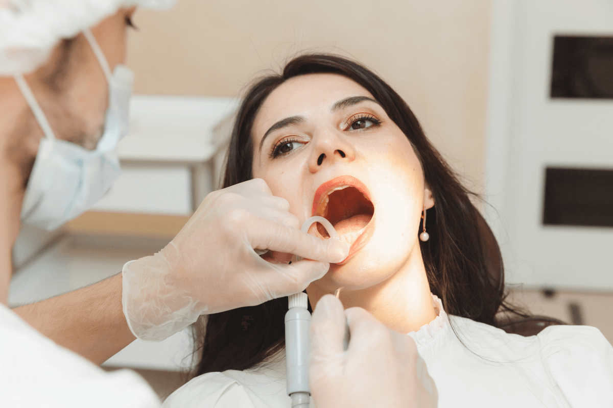 dentist patient dental office doctor treats teeth young woman with drill hygiene healthy teeth